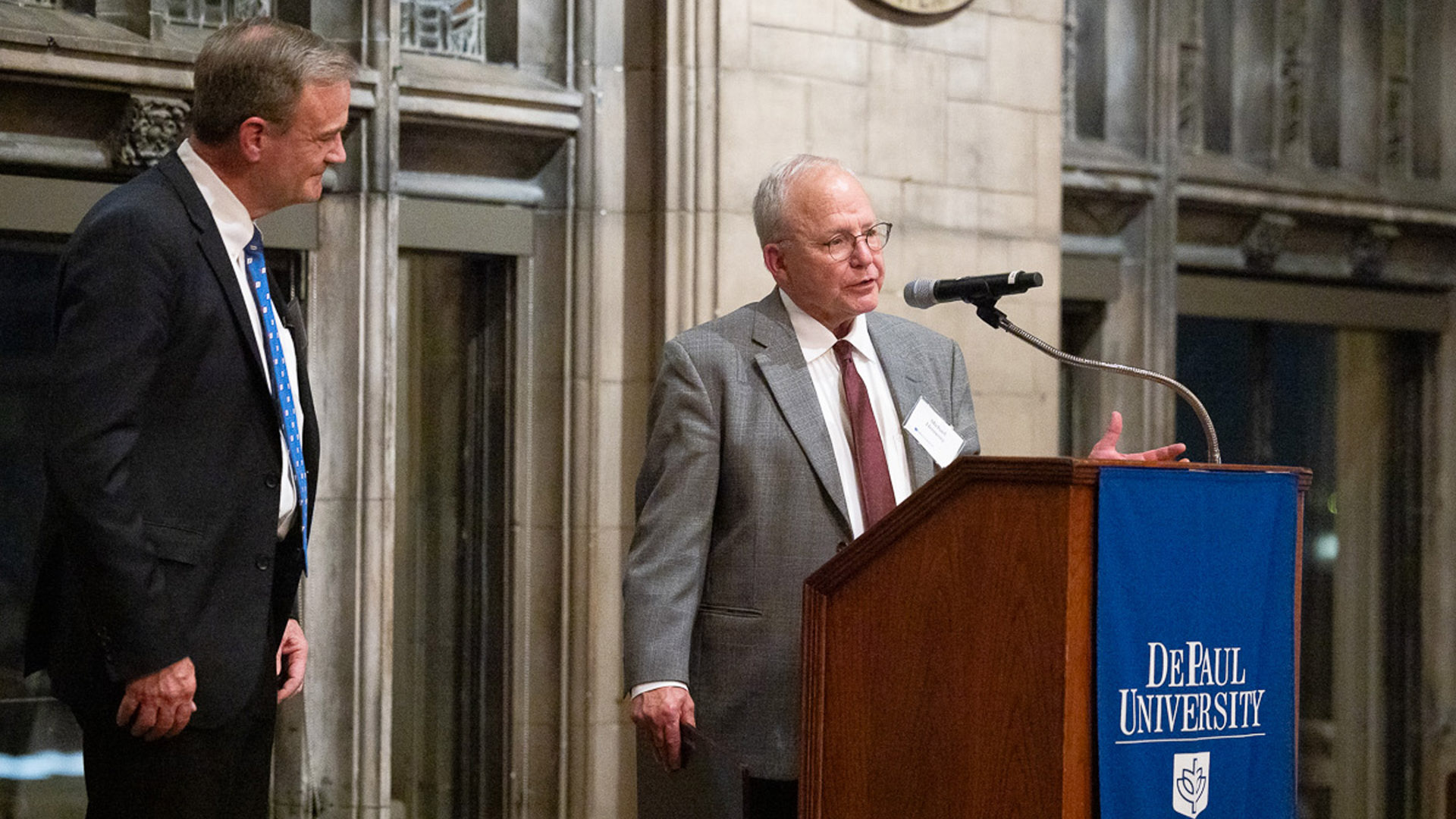 Mike Hennessy, president of the Coleman Foundation from 1995 to 2020 and a key advocate for the creation of the center, speaks as Leech looks on.